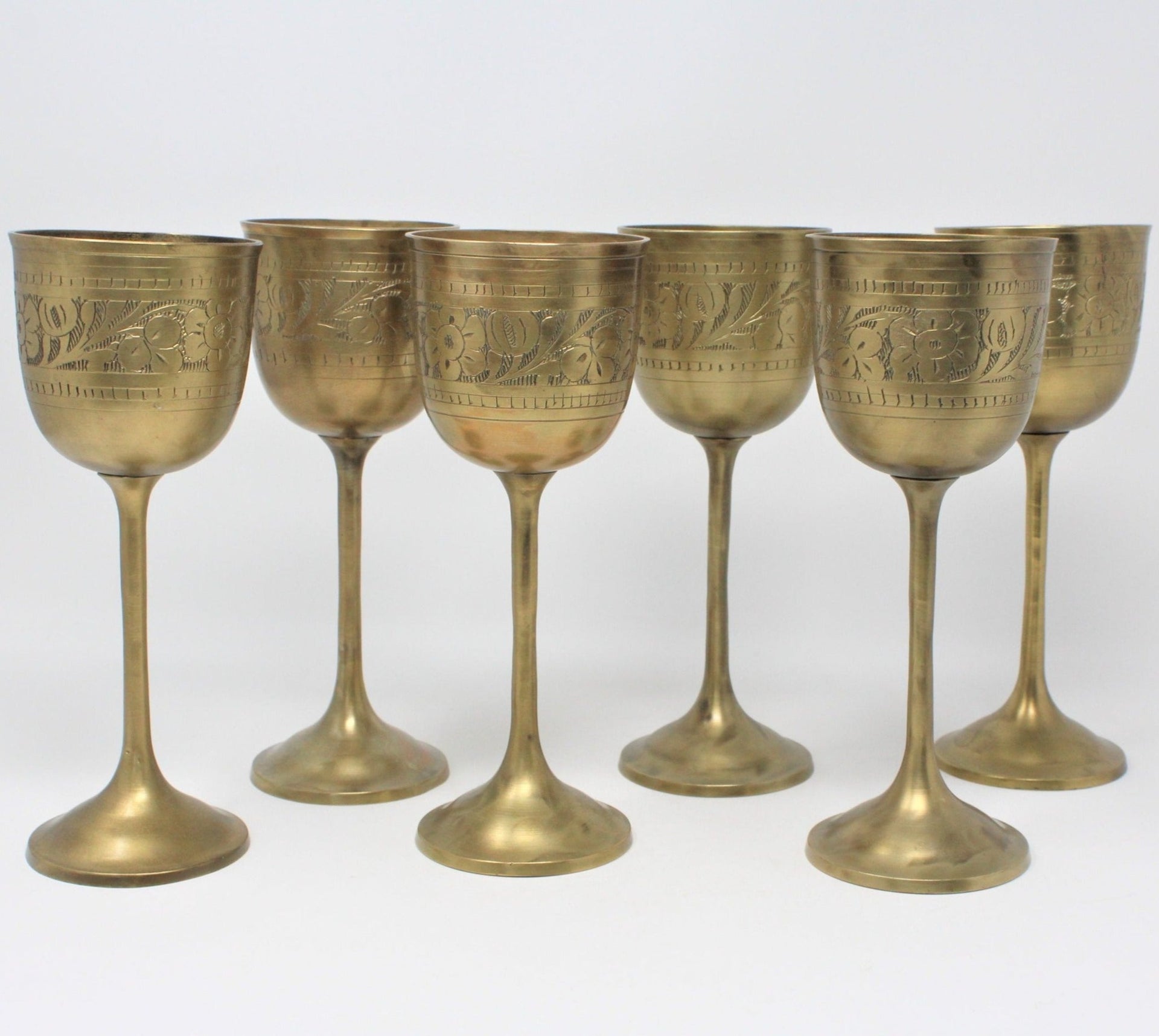Vintage brass wine glasses6 small wine glasses etched with Saudi Arabia  on one side and flowers on othermade in Pakistan.